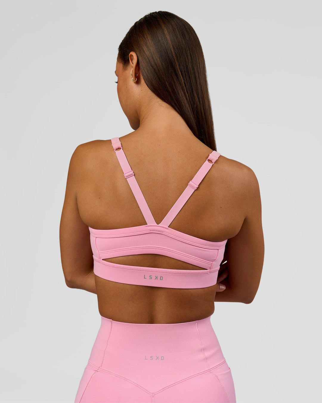 Woman wearing Momentum Sports Bra - Pink Rose | Model:Brylee | Size:XS - view 2