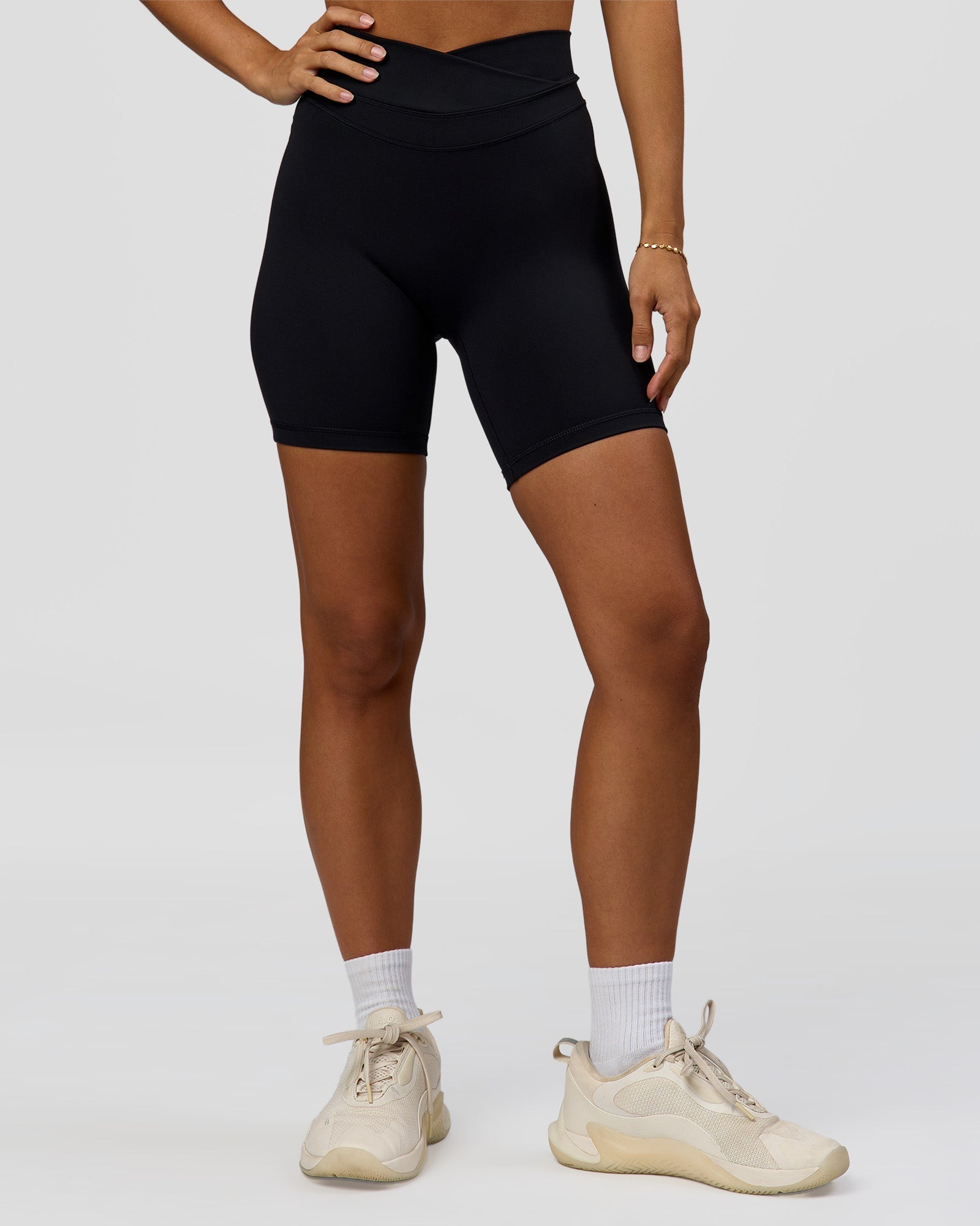 Woman wearing Solstice High-Rise 6" Short - Black | Model:Brylee | Size:XS