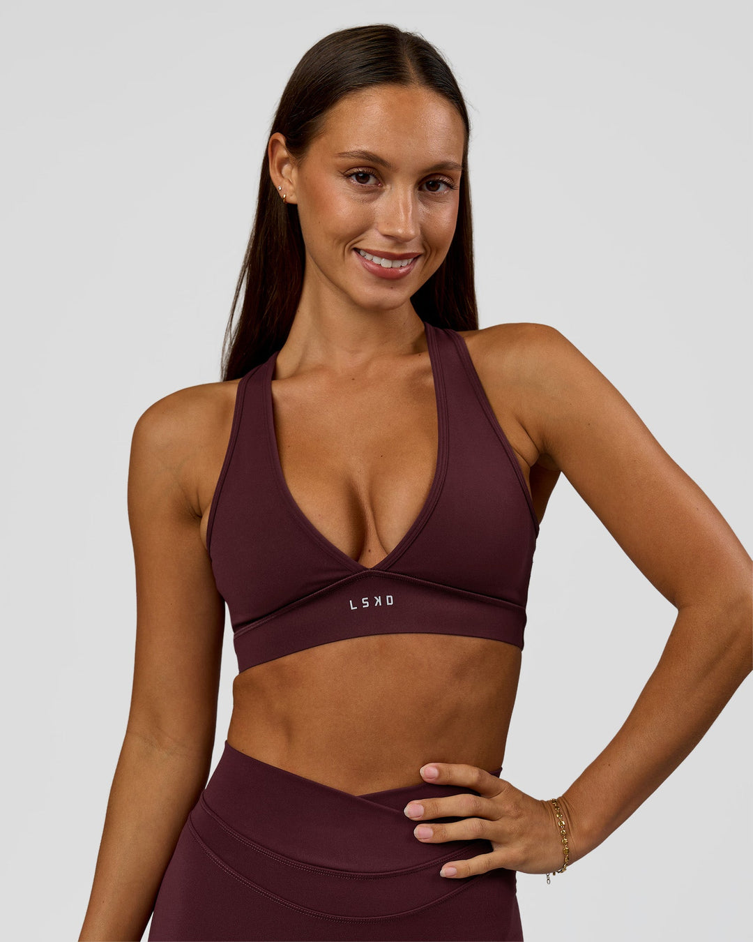 Woman wearing Stamina Sports Bra - Cherry Lacquer | Model:Brylee | Size:XS - view 1
