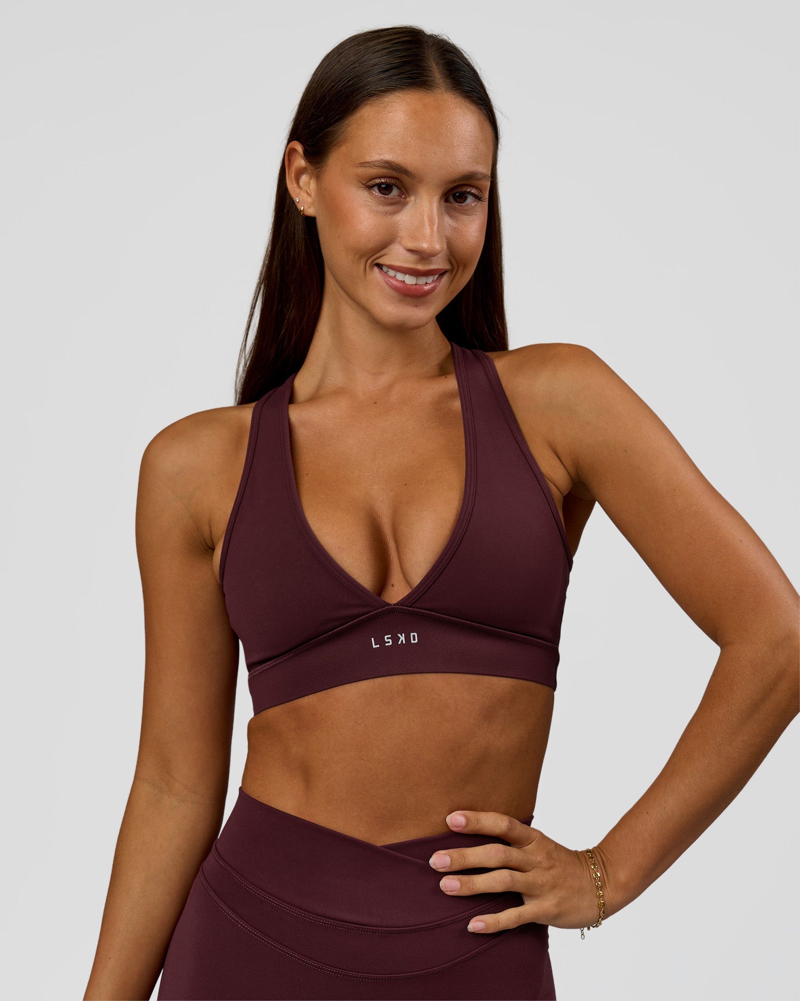 Woman wearing Stamina Sports Bra - Cherry Lacquer | Model:Brylee | Size:XS