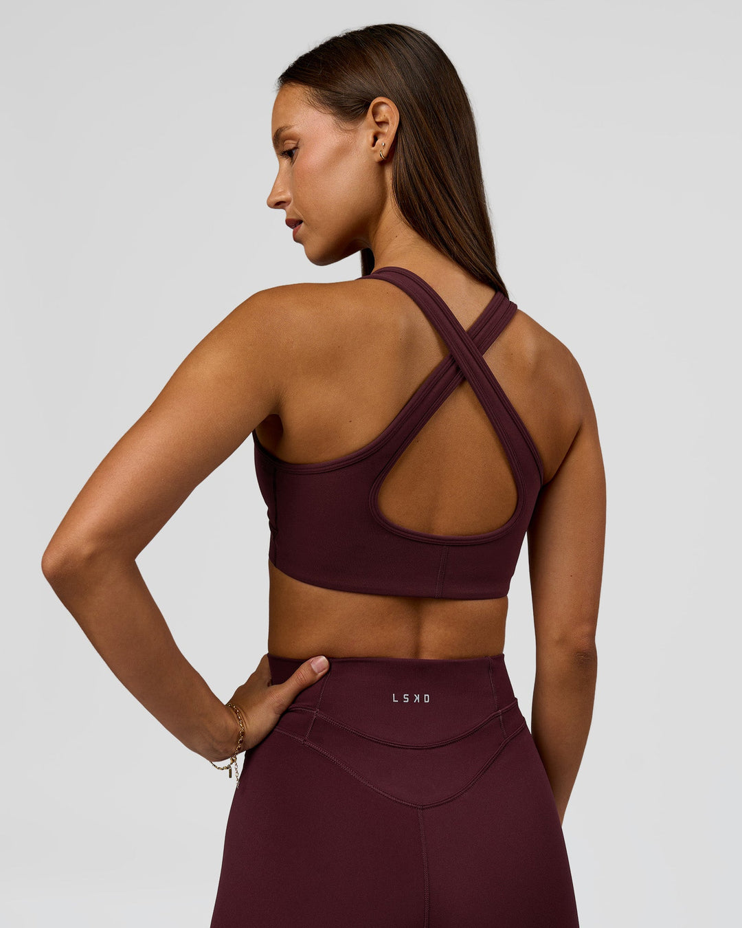 Woman wearing Stamina Sports Bra - Cherry Lacquer | Model:Brylee | Size:XS - view 2