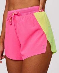 Woman wearing Accelerate 3" High-Rise Running Short - Lime Glo-Sugar Plum | Model:Charli | Size:XS | Thumbnail Index: 0