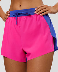 Woman wearing Accelerate 3" High-Rise Running Short - Power Cobalt-Ultra Pink | Model:Charli | Size:XS | Thumbnail Index: 0