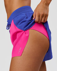 Woman wearing Accelerate 3" High-Rise Running Short - Power Cobalt-Ultra Pink | Model:Charli | Size:XS