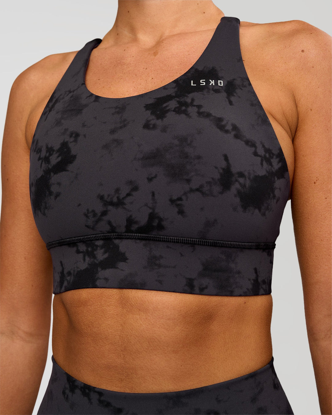 Woman wearing Accelerate Split Strap Sports Bra - Black Tie Dye | Model:Charli | Size:XS - view 4