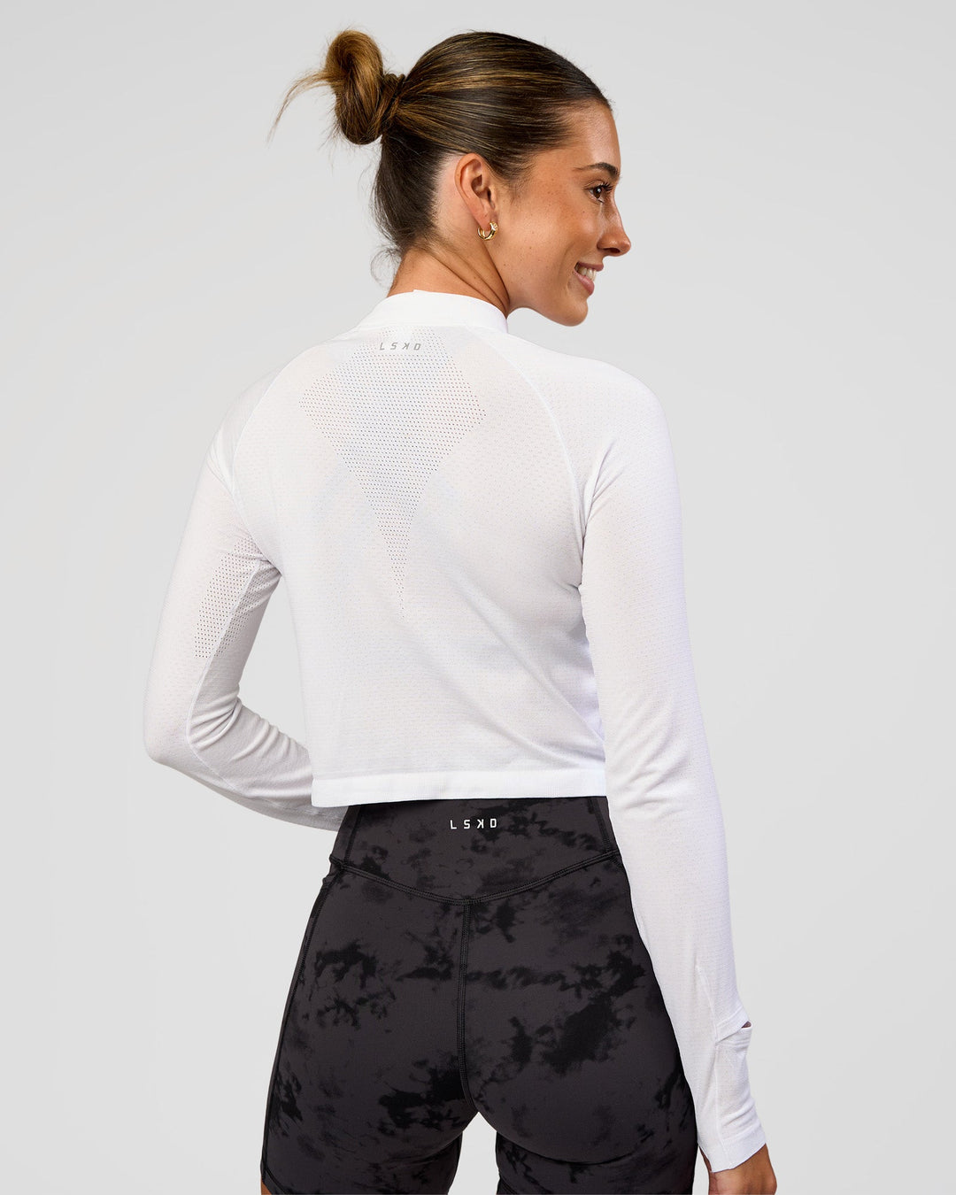 Woman wearing AeroFLX+ Long Sleeve Skimmer Half Zip - White/White | Model:Charli | Size:XS - view 2