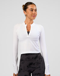 Woman wearing AeroFLX+ Long Sleeve Skimmer Half Zip - White/White | Model:Charli | Size:XS | Thumbnail Index: 0