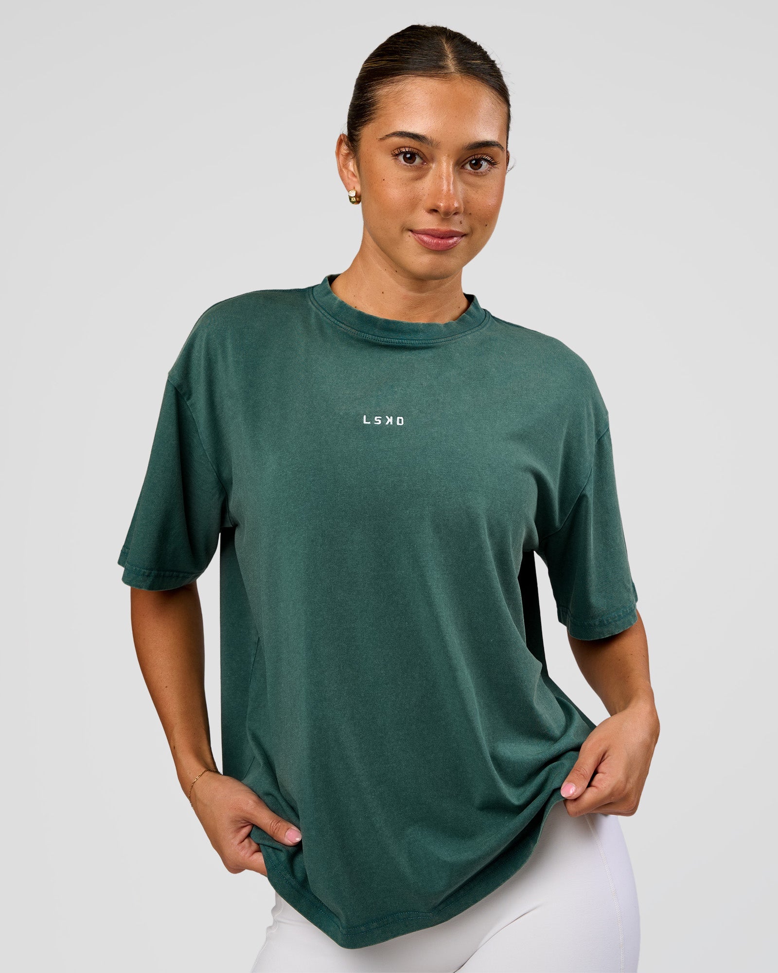 Woman wearing Go-To FLXCotton Oversized Tee - Transformative Teal Washed-White | Model:Charli | Size:XS