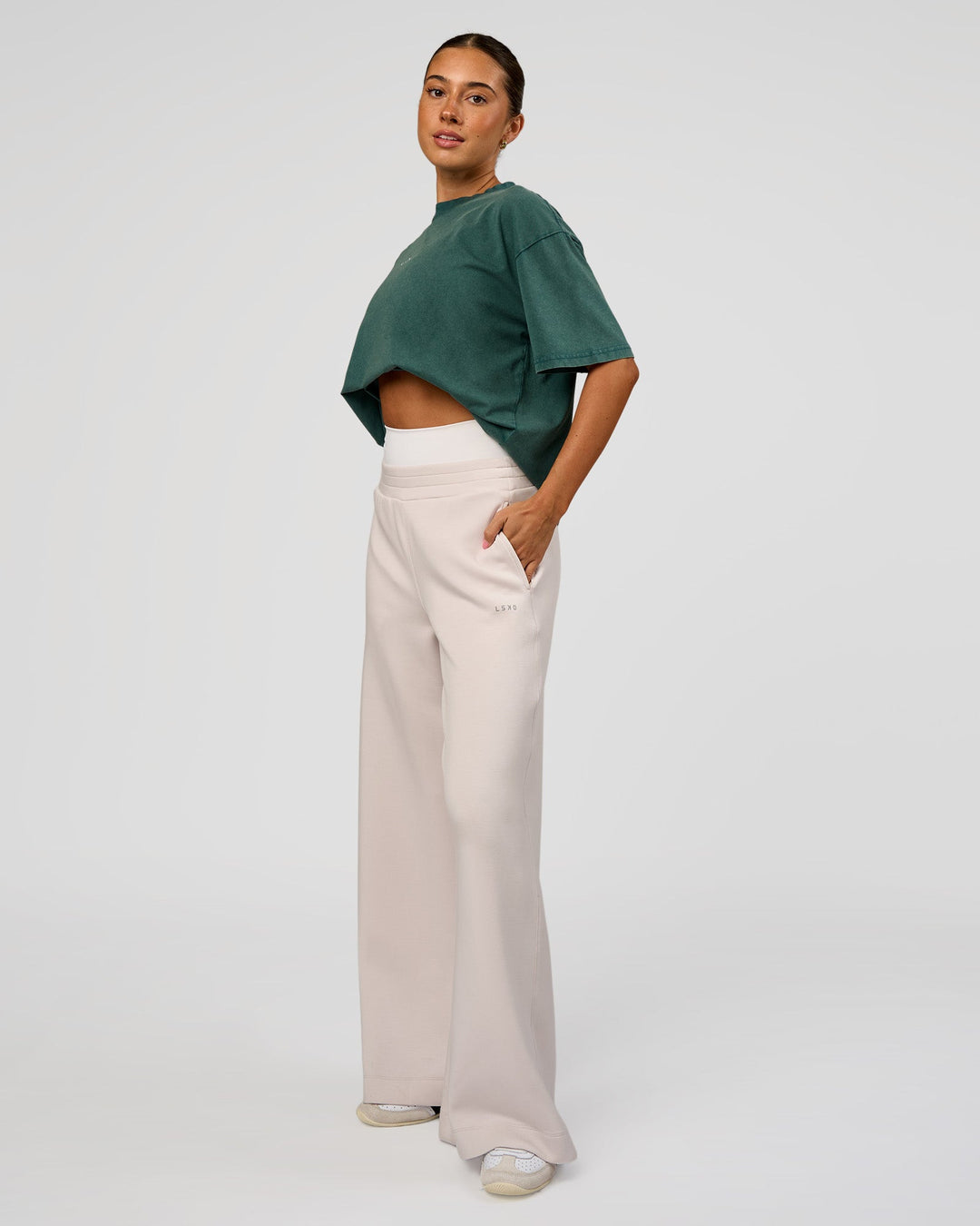 Woman wearing Go-To FLXCotton Oversized Tee - Transformative Teal Washed-White | Model:Charli | Size:XS