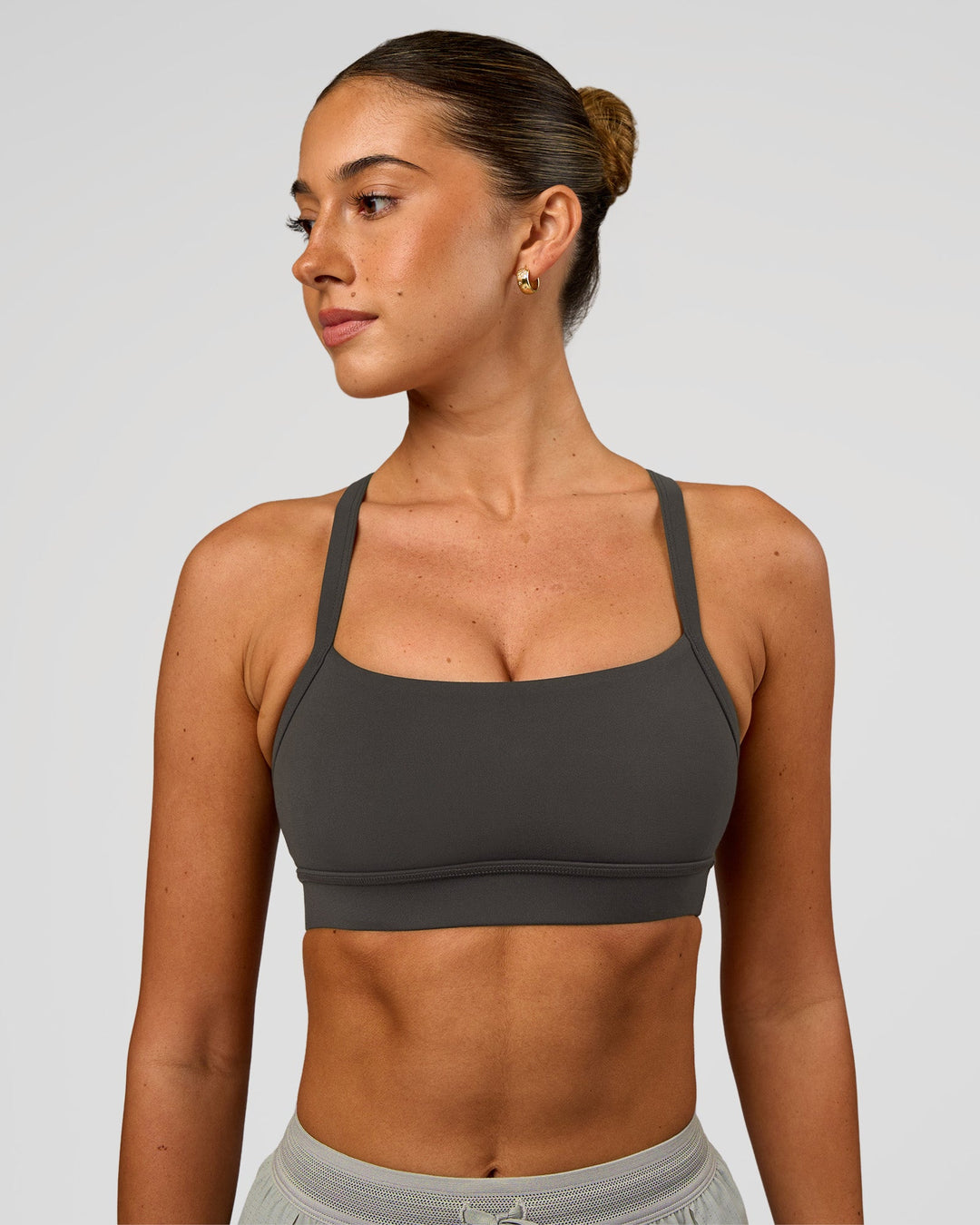 Woman wearing Momentum Sports Bra - Onyx | Model:Charli | Size:XS - view 1