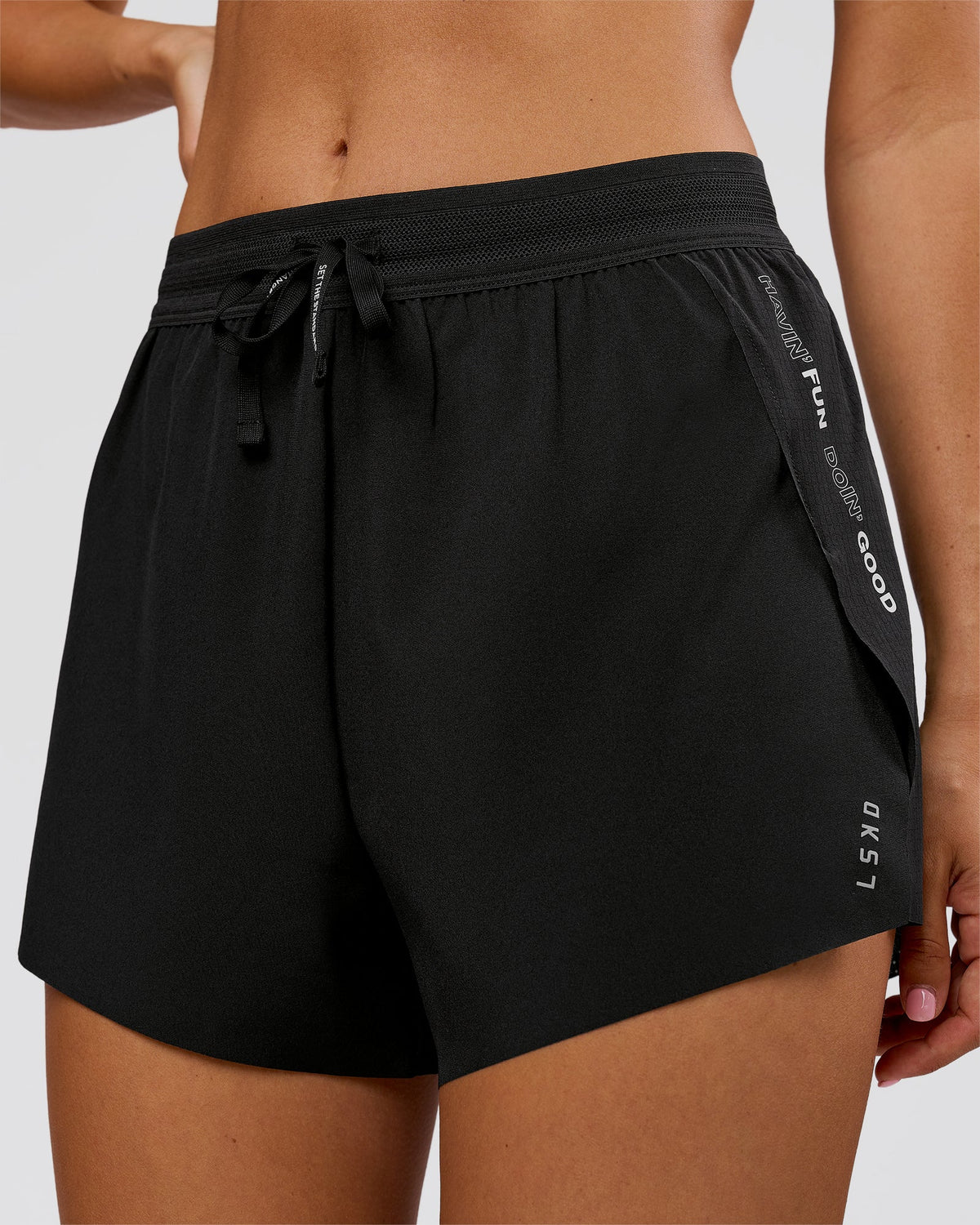 Woman wearing Movember x LSKD Accelerate 3" High-Rise Running Short - Black | Model:Charli | Size:XS - view 2