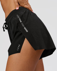Woman wearing Movember x LSKD Accelerate 3" High-Rise Running Short - Black | Model:Charli | Size:XS | Thumbnail Index: 2