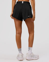 Woman wearing Movember x LSKD Accelerate 3" High-Rise Running Short - Black | Model:Charli | Size:XS | Thumbnail Index: 4