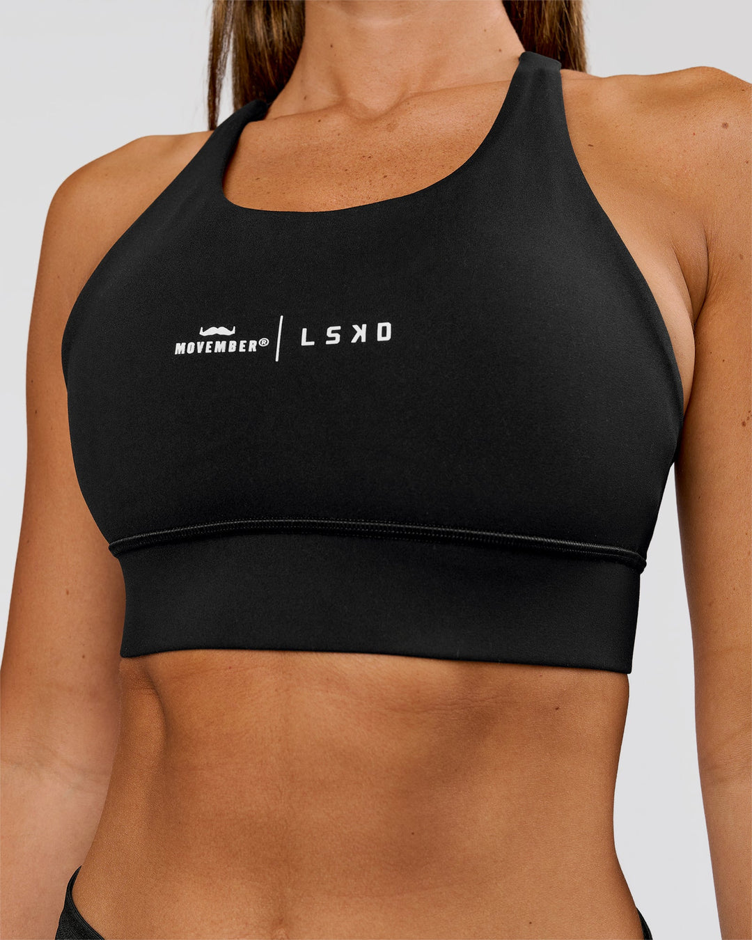 Woman wearing Movember x LSKD Accelerate Sports Bra - Black | Model:Charli | Size:XS - view 3