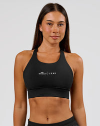 Woman wearing Movember x LSKD Accelerate Sports Bra - Black | Model:Charli | Size:XS | Thumbnail Index: 0