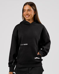 Woman wearing Movember x LSKD Oversized Hoodie - Black | Model:Charli | Size:XS | Thumbnail Index: 2
