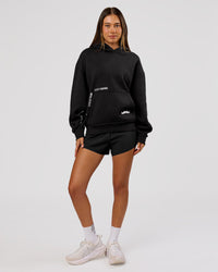 Woman wearing Movember x LSKD Oversized Hoodie - Black | Model:Charli | Size:XS | Thumbnail Index: 7