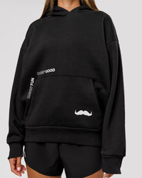 Woman wearing Movember x LSKD Oversized Hoodie - Black | Model:Charli | Size:XS | Thumbnail Index: 13
