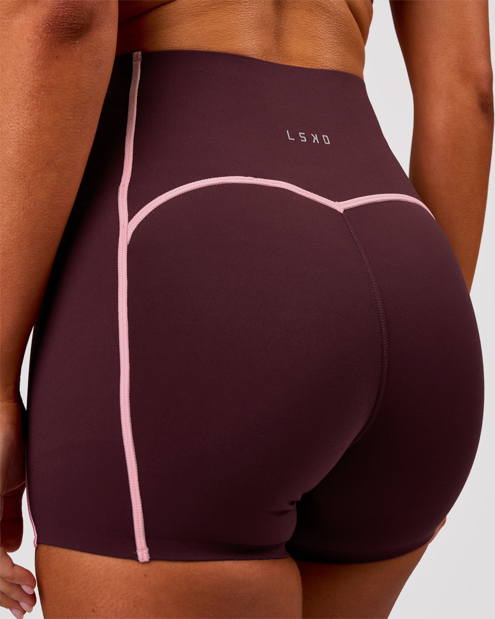 Woman wearing Power Ultra High-Rise 4" Short Pockets - Cherry Lacquer-Pink Rose | Model:Charli | Size:XS