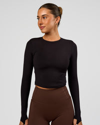 Woman wearing Staple Long Sleeve Cropped Tee 2.0 - Black | Model:Charli | Size:XS | Thumbnail Index: 0