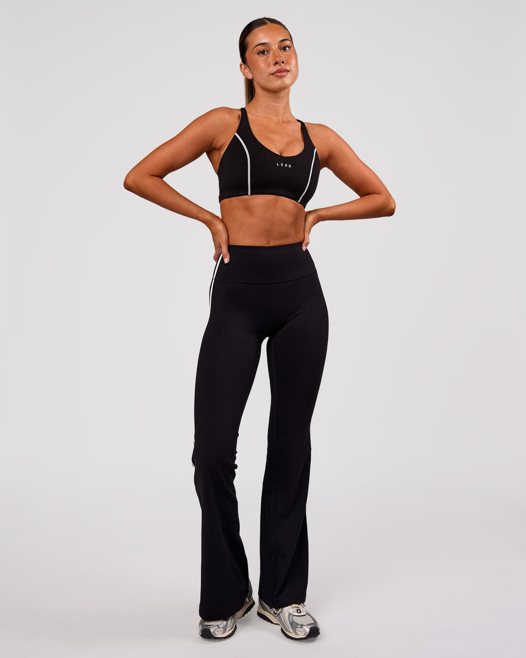 Woman wearing Stellar Sports Bra - Black-White | Model:Charli | Size:XS - view 3