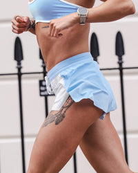 Woman wearing Accelerate 3" Mid-Rise Running Short - Open Air-White | Model:Charlotte | Size:XS | Thumbnail Index: 9