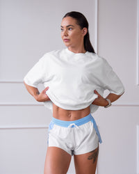 Woman wearing Accelerate 3" Mid-Rise Running Short - Open Air-White | Model:Charlotte | Size:XS | Thumbnail Index: 11