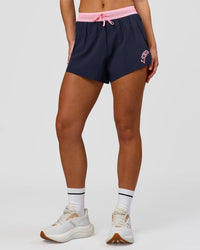 Woman wearing Accelerate 3" High-Rise Running Short - Future Navy-Varsity print | Model:Issy | Size:XS | Thumbnail Index: 5