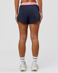Woman wearing Accelerate 3" High-Rise Running Short - Future Navy-Varsity print | Model:Issy | Size:XS | Thumbnail Index: 7