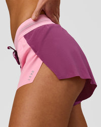 Woman wearing Accelerate 3" Mid-Rise Running Short - Boysenberry-Pink Rose | Model:Issy | Size:XS | Thumbnail Index: 0