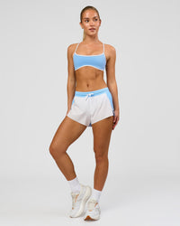 Woman wearing Accelerate 3" Mid-Rise Running Short - Open Air-White | Model:Issy | Size:XS | Thumbnail Index: 2