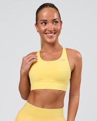 Woman wearing Accelerate Sports Bra - Lemon | Model:Issy | Size:XS | Thumbnail Index: 0