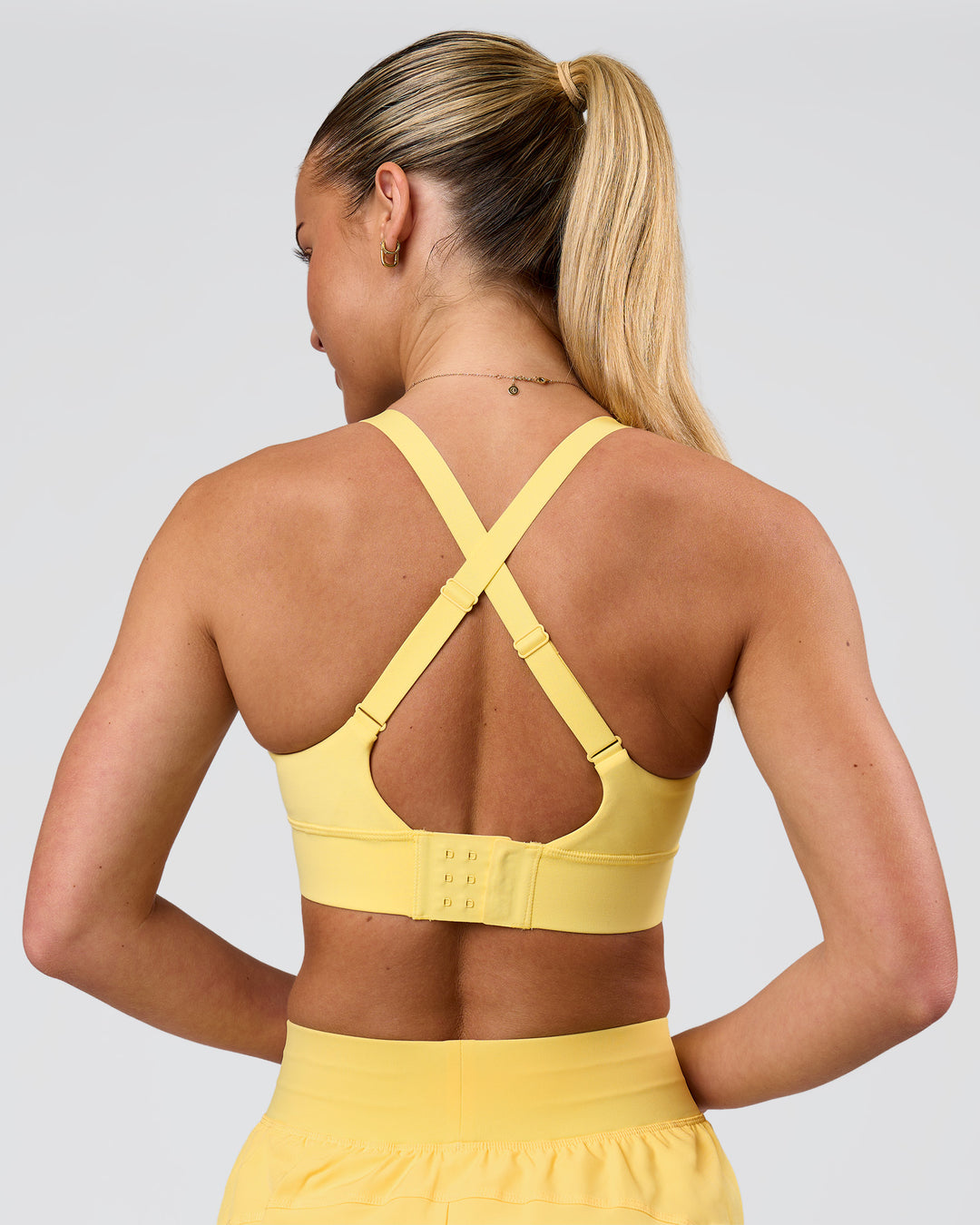 Woman wearing Accelerate Sports Bra - Lemon | Model:Issy | Size:XS - view 2