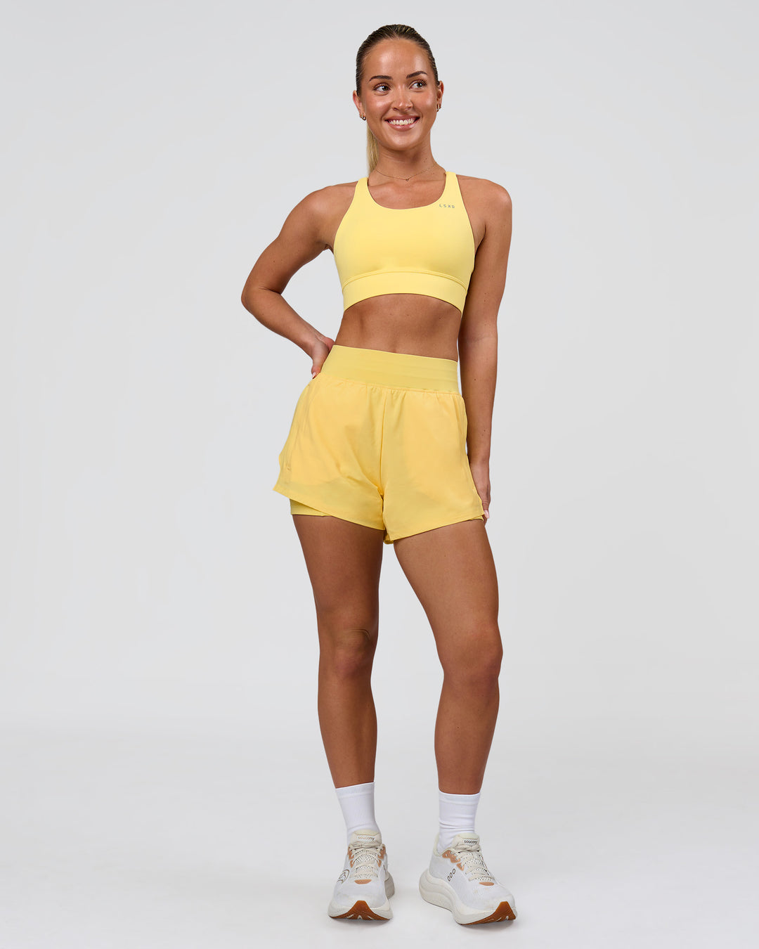 Woman wearing Accelerate Sports Bra - Lemon | Model:Issy | Size:XS - view 4
