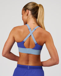 Woman wearing Accelerate Sports Bra - Power Cobalt-Open Air | Model:Issy | Size:XS | Thumbnail Index: 2