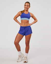 Woman wearing Accelerate Sports Bra - Power Cobalt-Open Air | Model:Issy | Size:XS | Thumbnail Index: 3