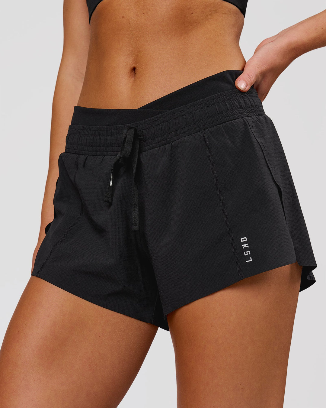 Woman wearing Accelerate Synergy 3" Running Short Short - Black-Black | Model:Issy | Size:XS - view 1
