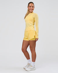 Woman wearing AeroFLX+ Long Sleeve Half Zip - Lemon/Lemon | Model:Issy | Size:XS | Thumbnail Index: 4