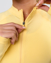 Woman wearing AeroFLX+ Long Sleeve Half Zip - Lemon/Lemon | Model:Issy | Size:XS | Thumbnail Index: 5