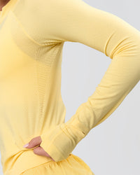 Woman wearing AeroFLX+ Long Sleeve Half Zip - Lemon/Lemon | Model:Issy | Size:XS | Thumbnail Index: 7