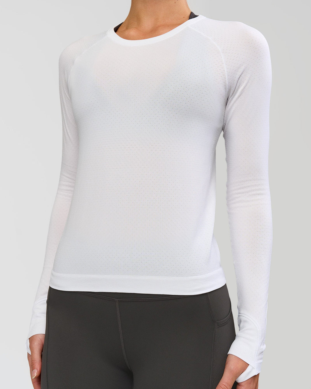 Woman wearing AeroFLX+ Seamless Long Sleeve Tee - White/White | Model:Issy | Size:XS - view 3