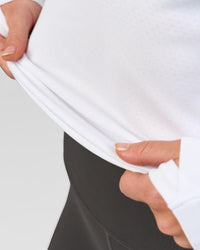Woman wearing AeroFLX+ Seamless Long Sleeve Tee - White/White | Model:Issy | Size:XS | Thumbnail Index: 4