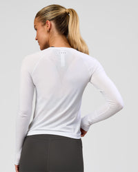 Woman wearing AeroFLX+ Seamless Long Sleeve Tee - White/White | Model:Issy | Size:XS | Thumbnail Index: 6