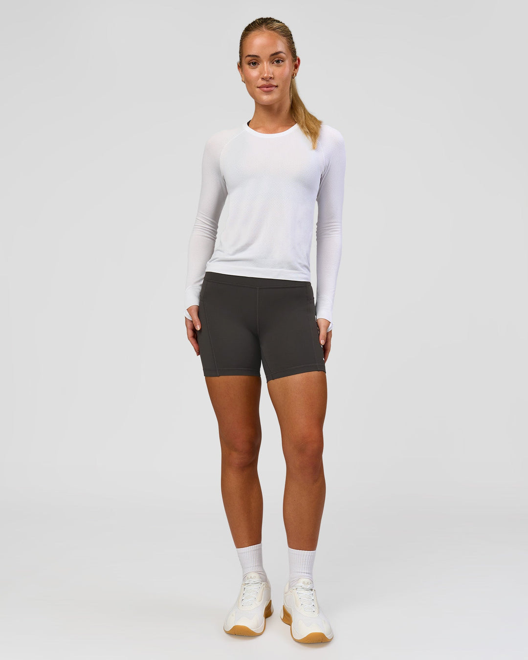 Woman wearing AeroFLX+ Seamless Long Sleeve Tee - White/White | Model:Issy | Size:XS - view 8