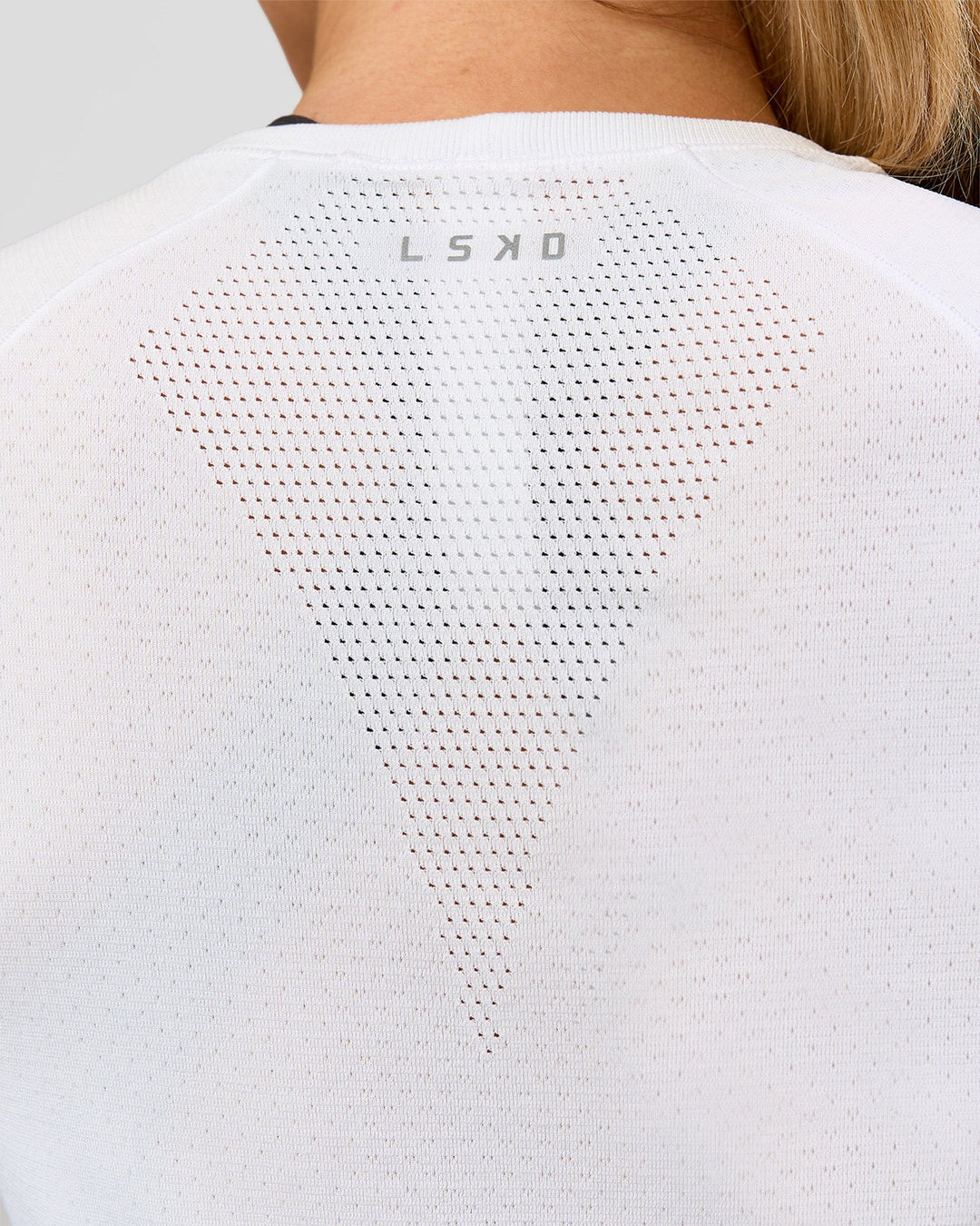 Woman wearing AeroFLX+ Seamless Long Sleeve Tee - White/White | Model:Issy | Size:XS - view 10