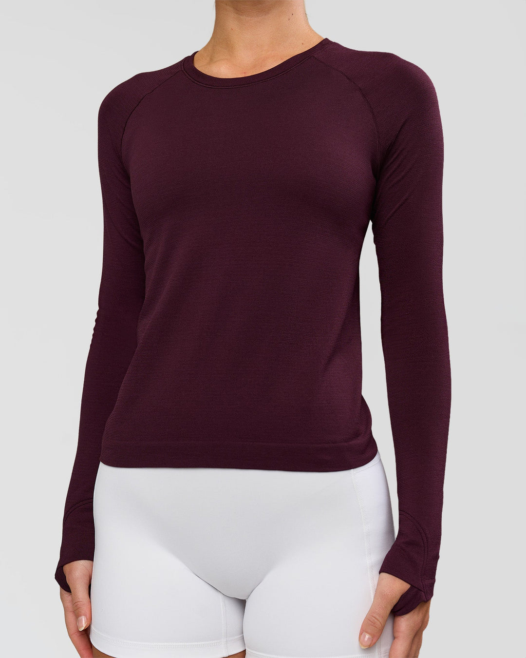 Woman wearing AeroFLX+ Seamless Long Sleeve Tee - Cherry Lacquer/Cherry Lacquer | Model:Issy | Size:XS - view 2