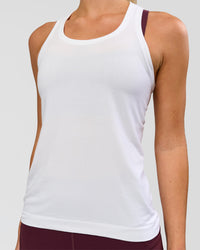 Woman wearing AeroFLX+ Seamless Tank - White/White | Model:Issy | Size:XS | Thumbnail Index: 0