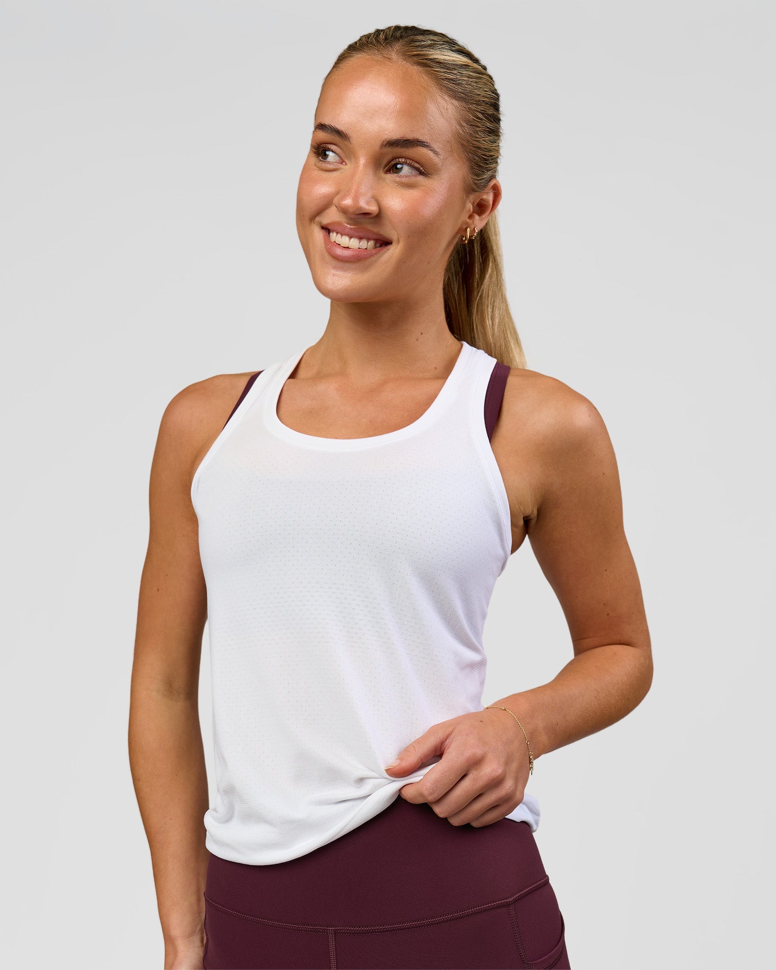 Woman wearing AeroFLX+ Seamless Tank - White/White | Model:Issy | Size:XS