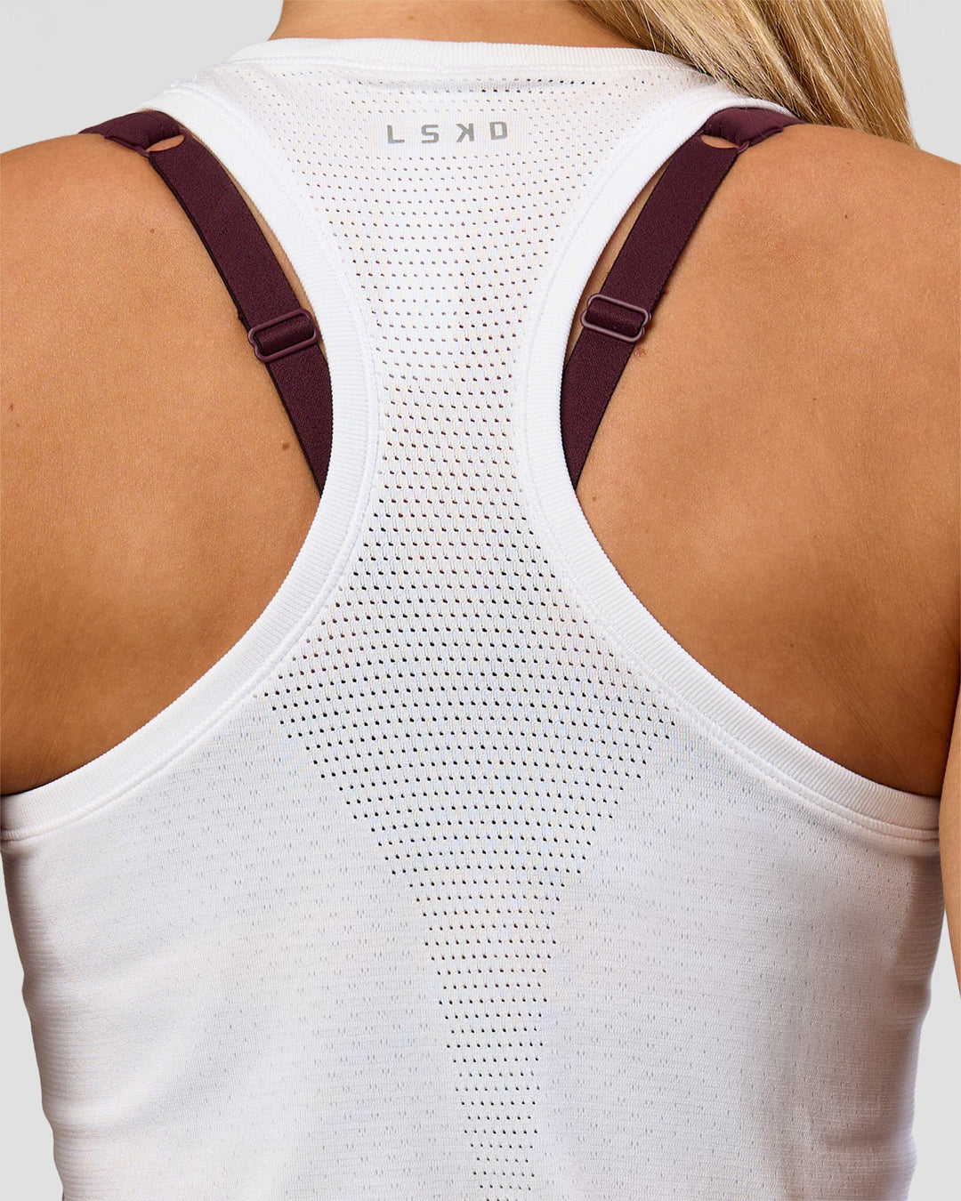 Woman wearing AeroFLX+ Seamless Tank - White/White | Model:Issy | Size:XS - view 3