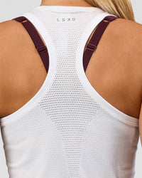 Woman wearing AeroFLX+ Seamless Tank - White/White | Model:Issy | Size:XS | Thumbnail Index: 2
